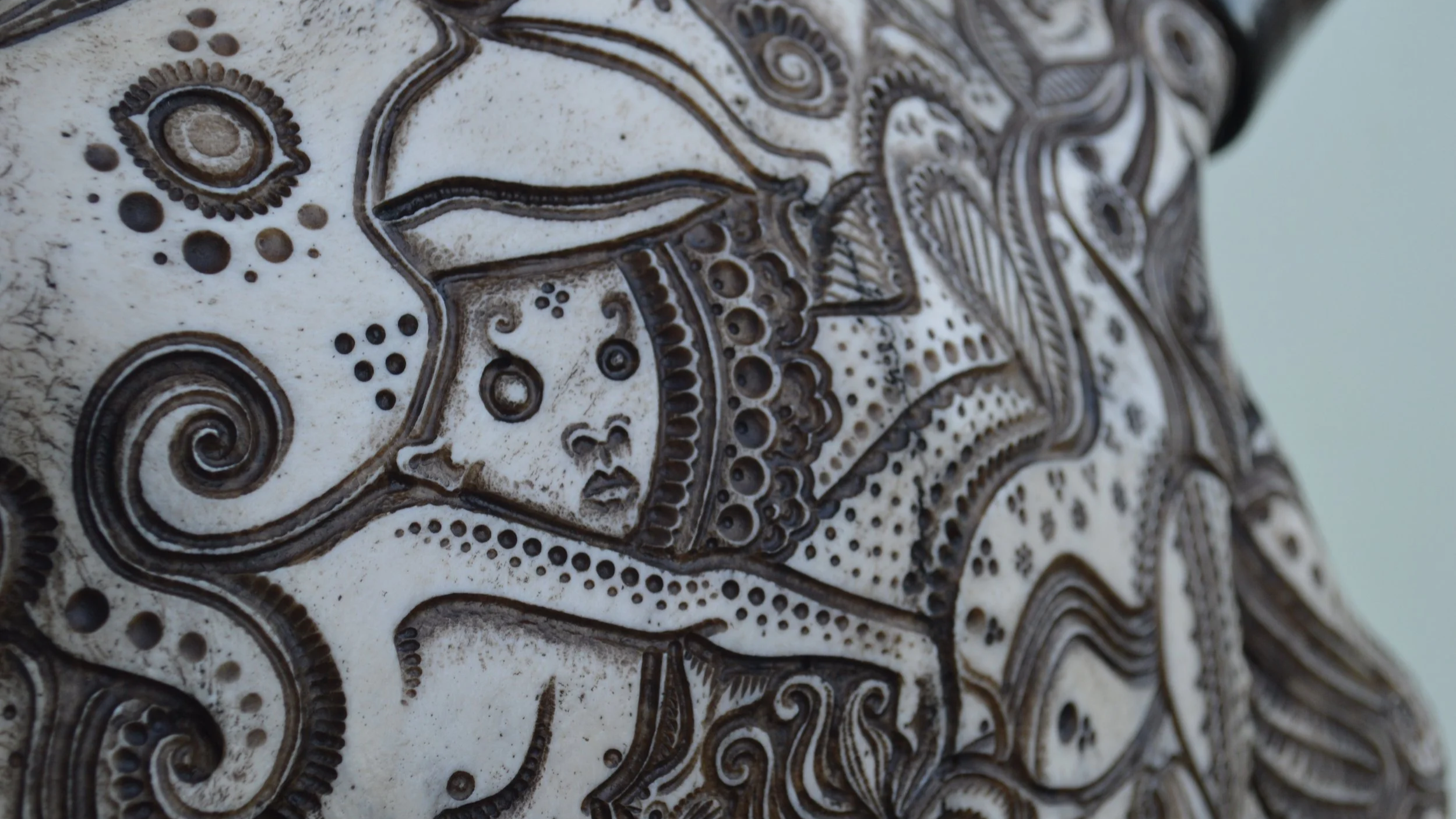 Sky-gods-Jason-borders-bone-carving.png