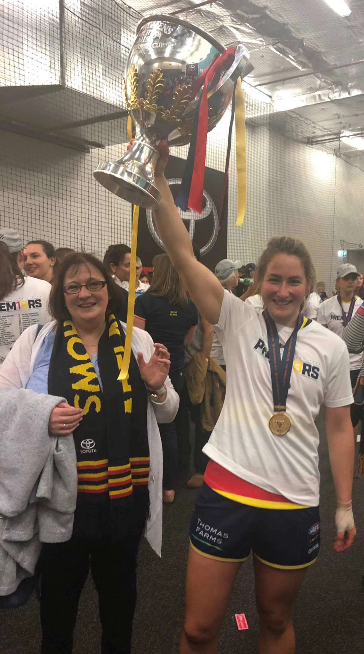 Ailish Considine of the Adelaide Crows with the AFLW Premiership Cup alongside proud mum Kay.