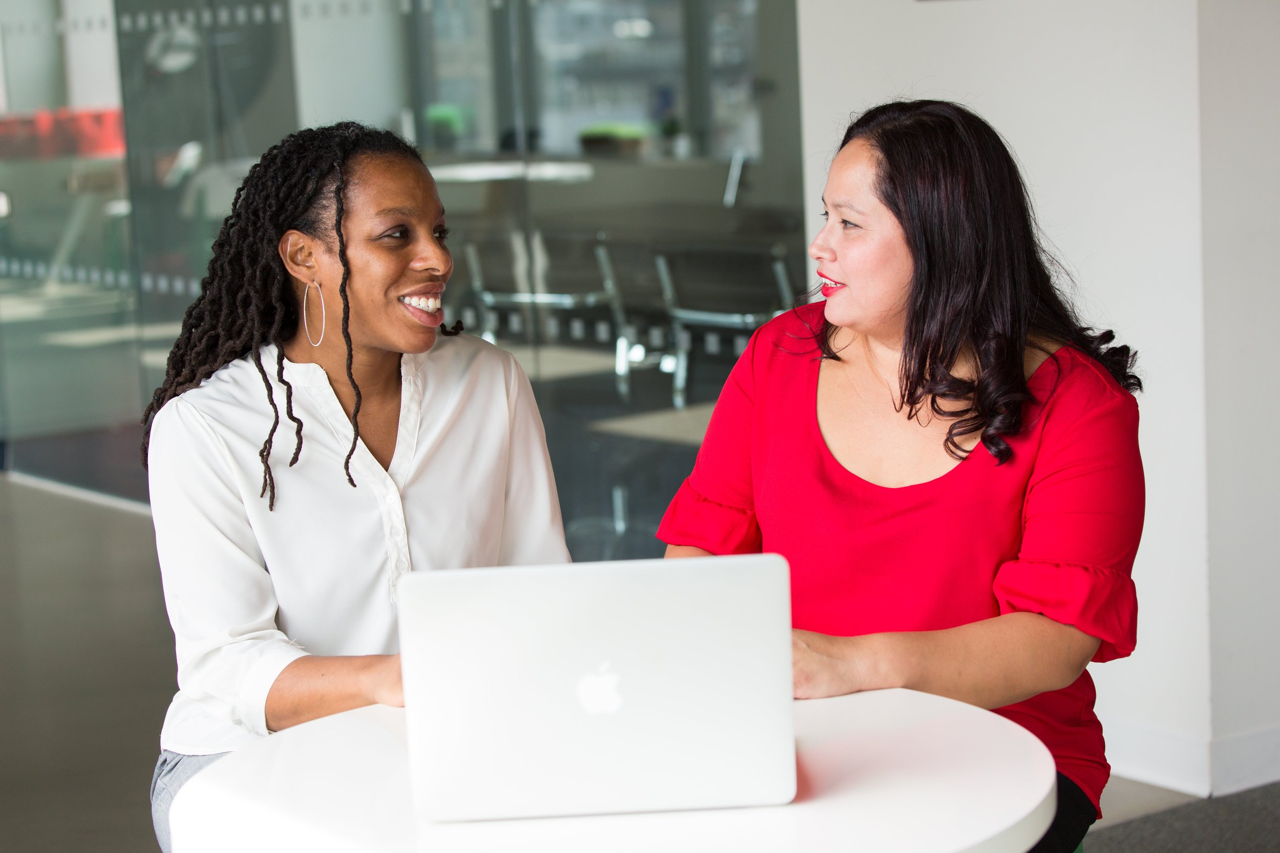 Two professionals having a strategy conversation at a table.