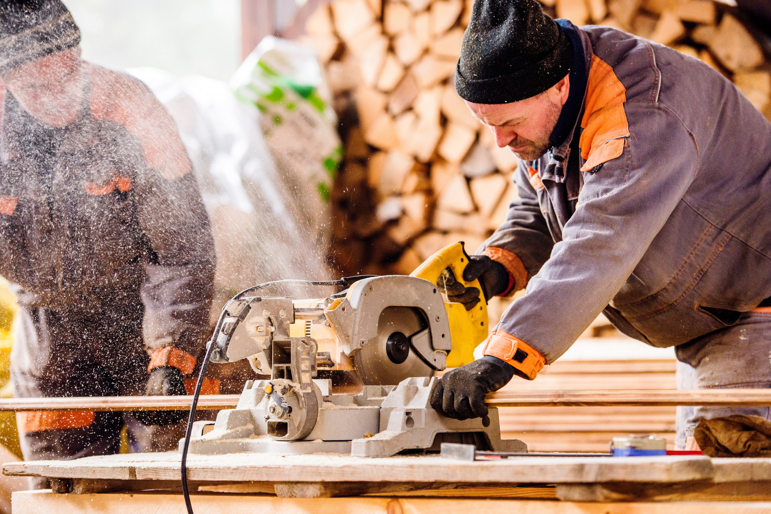graphicstock-carpenter-working-man-using-circular-saw-to-cut-planks-of-wood-for-home-construction_rOLx8OHfb.jpg