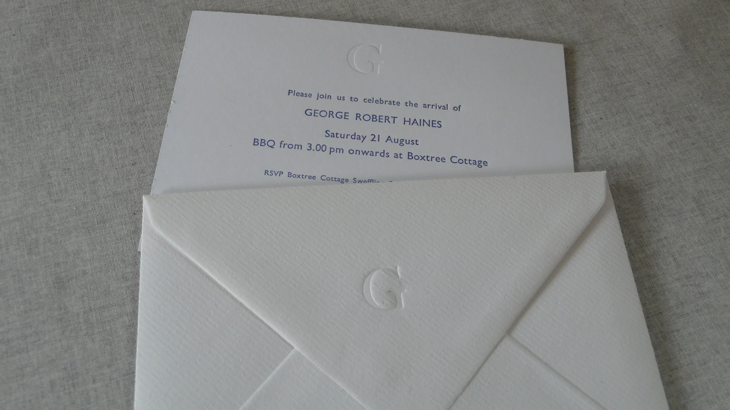 Birth announcement for George with debossed 'G' on card and envelope.