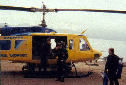 It is helpful to get the feel for what to hang on to and where to step when entering and egressing the helo while it is still on the ground. This exercise prepares divers to execute the skills smoothly when the helo is airborne and hovering over the water. Divers are allowed time to familiarize themselves with the aircraft.
