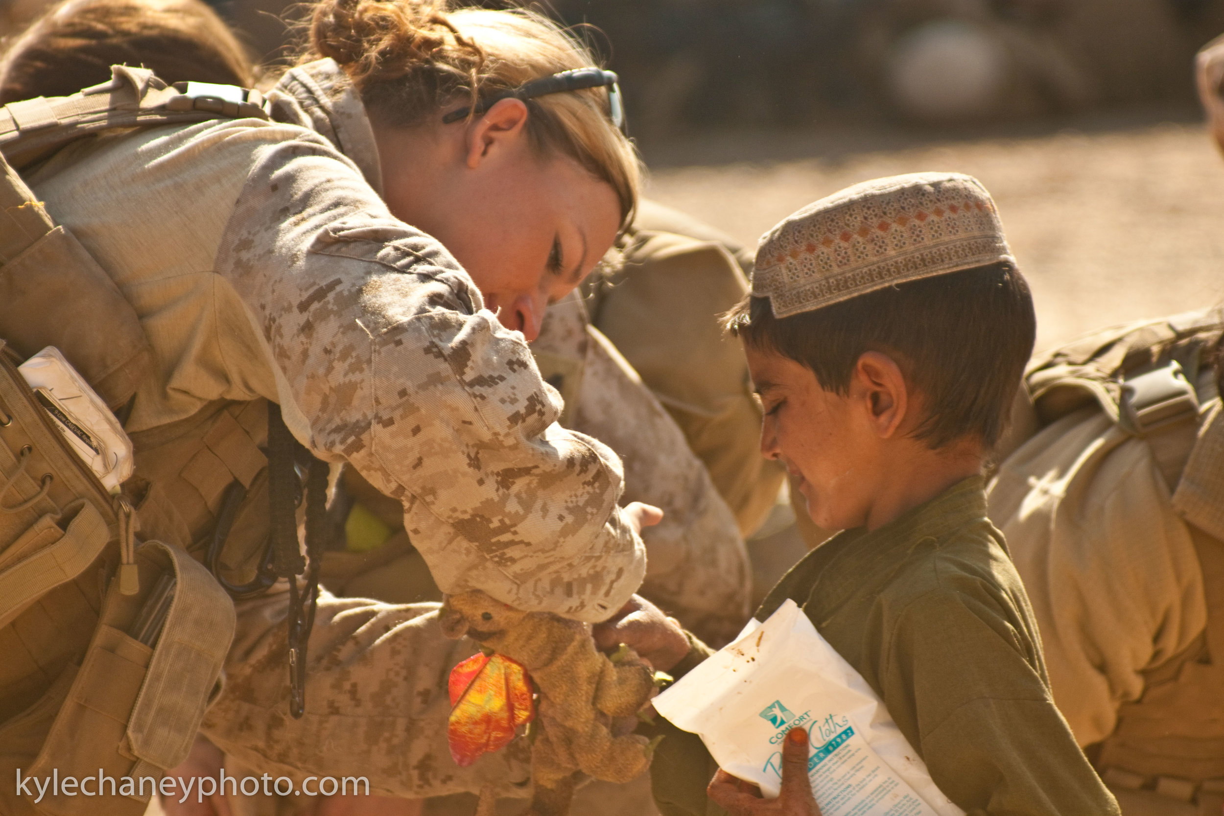 USMC Lioness Tends to Local Childs Wound