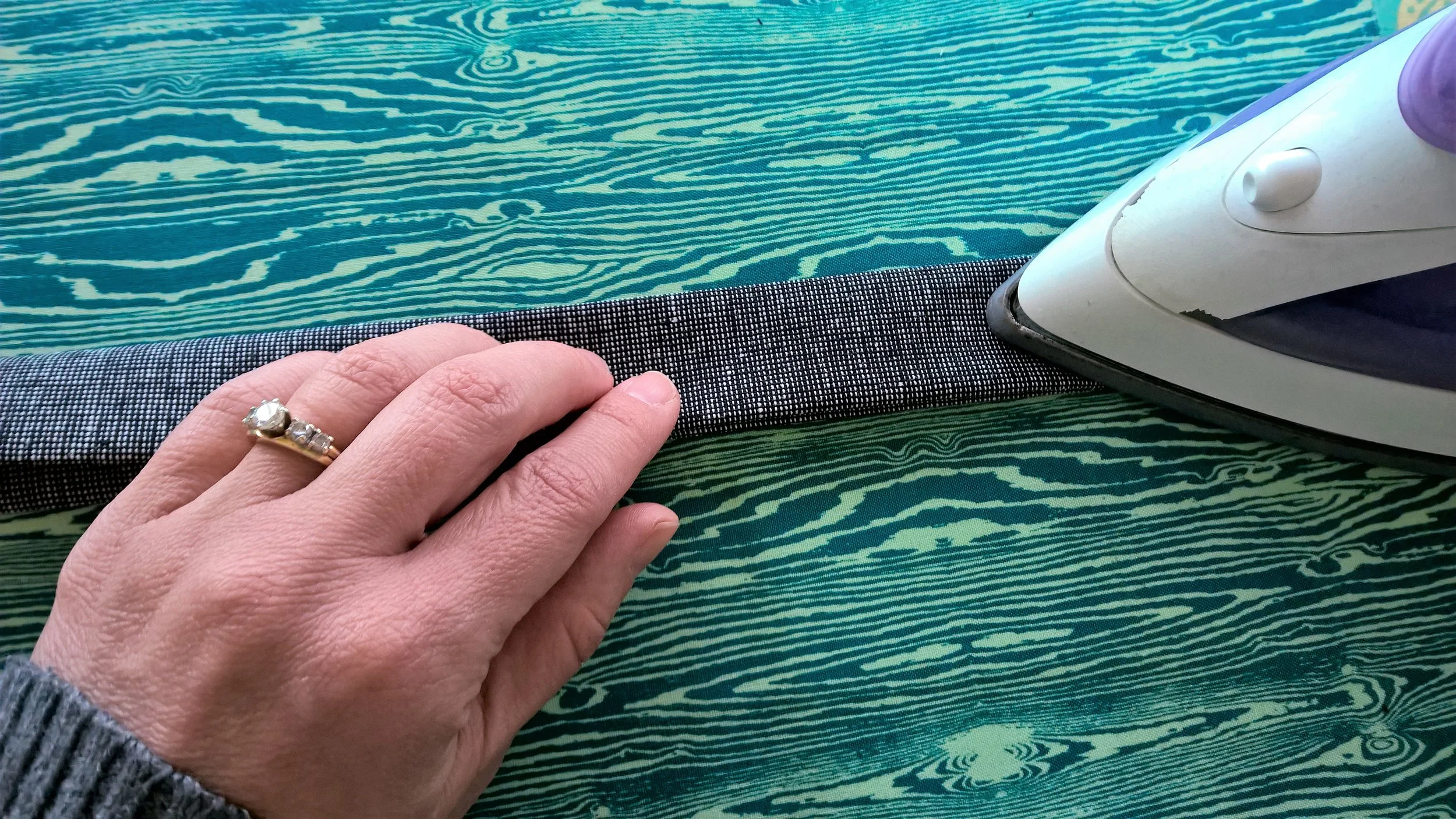 Top half folded down along center crease to meet bottom half and pressing.