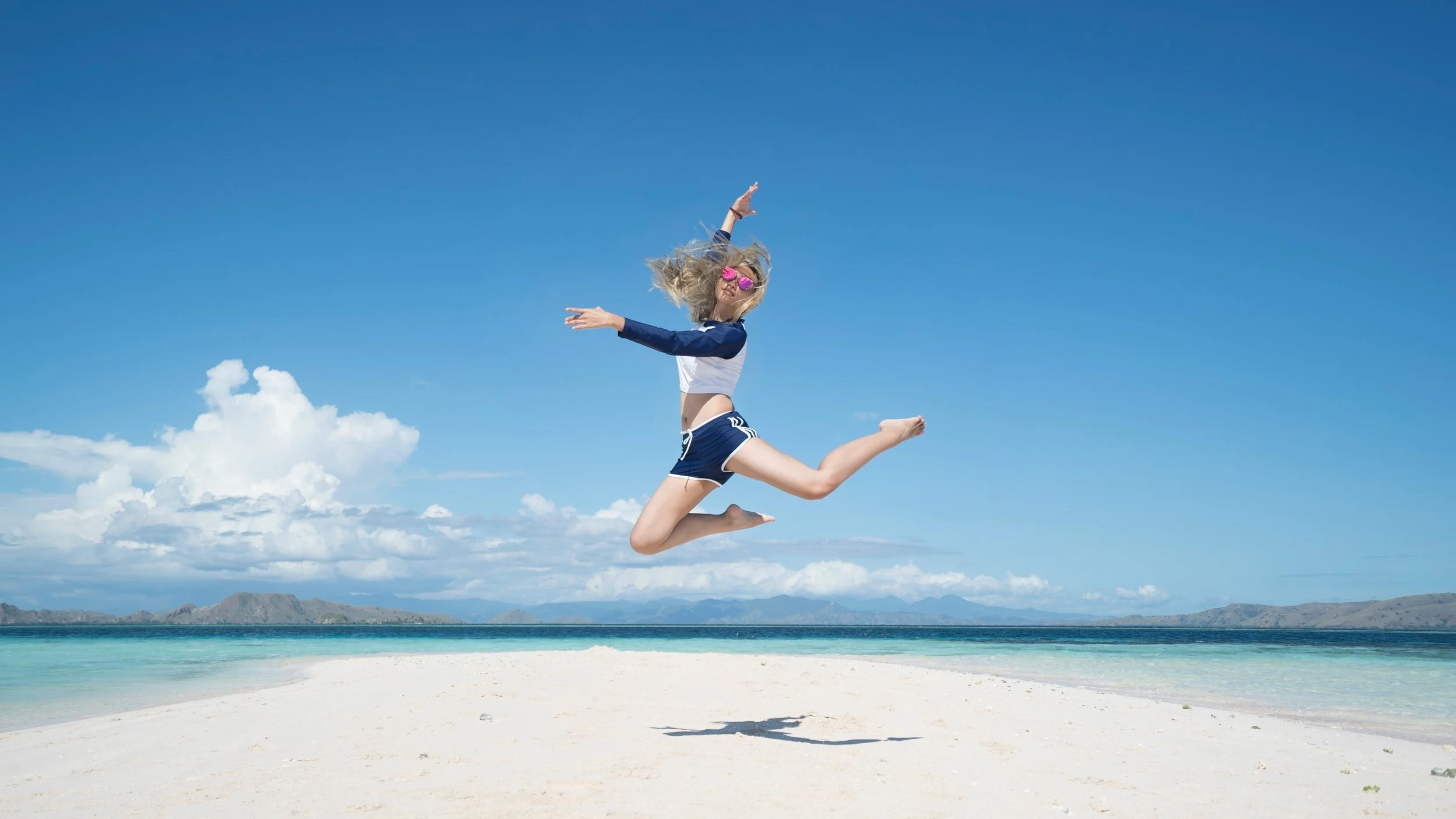 Rosie jumping for joy after saving £1,300 for her holiday in the Caribbean.