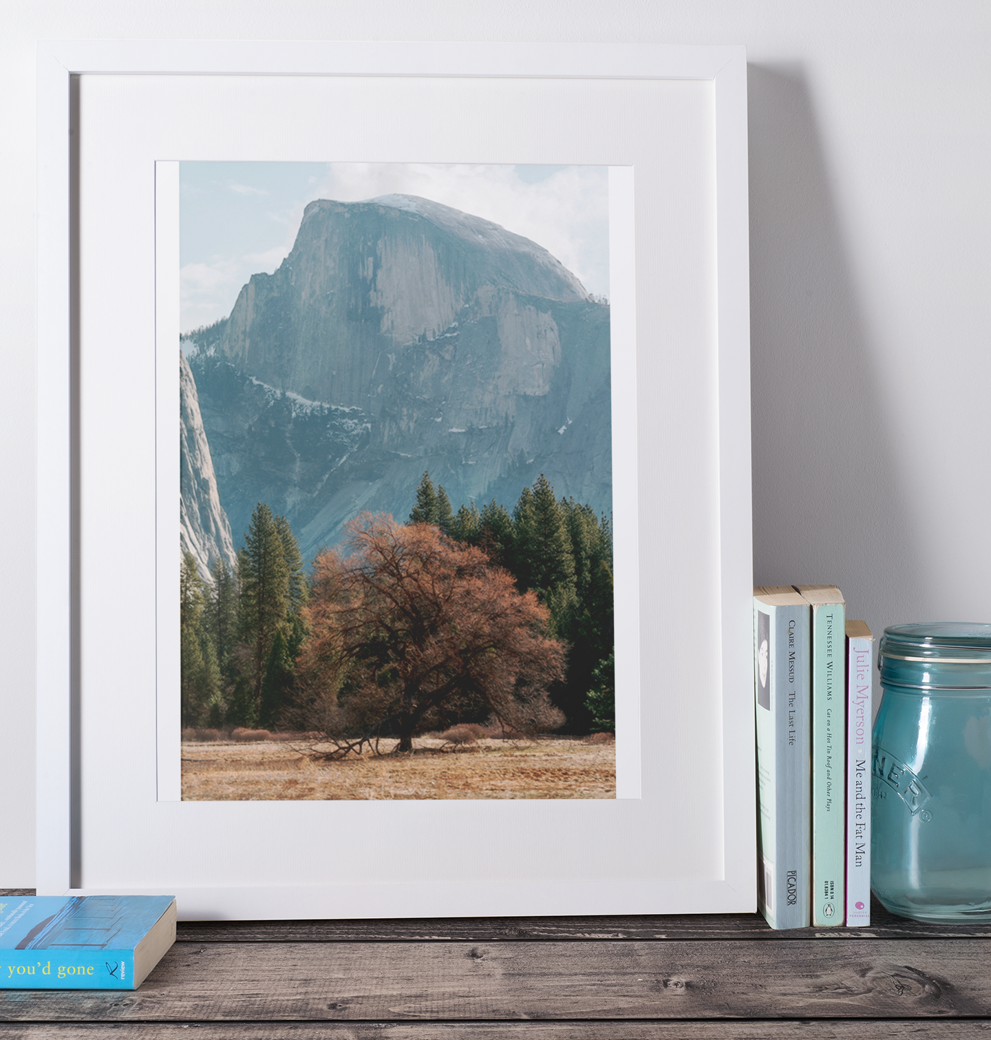 mockup-of-a-picture-frame-placed-over-a-wooden-surface-by-some-books-598-el.png