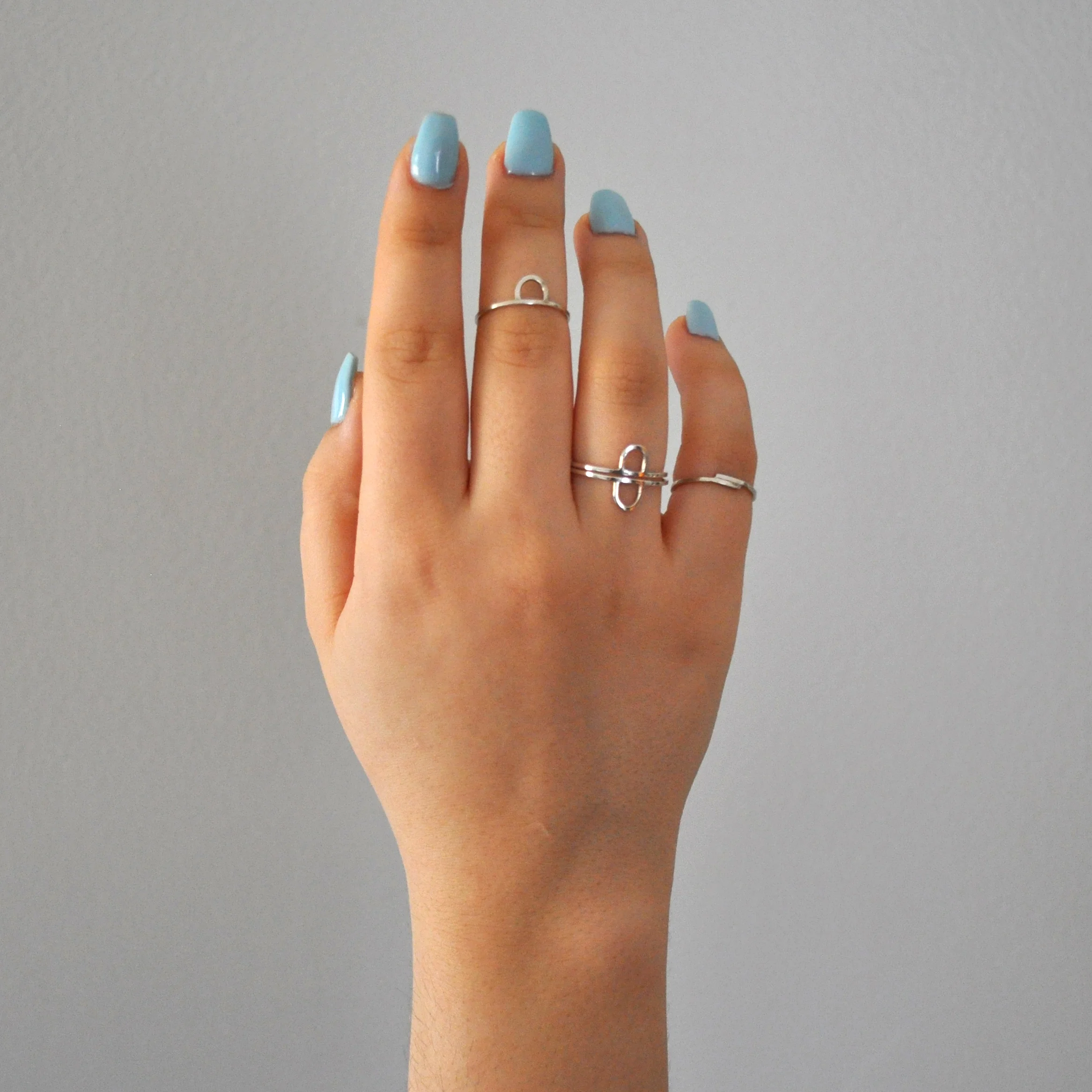 geometric-dainty-round-stacking-rings-hand.jpg