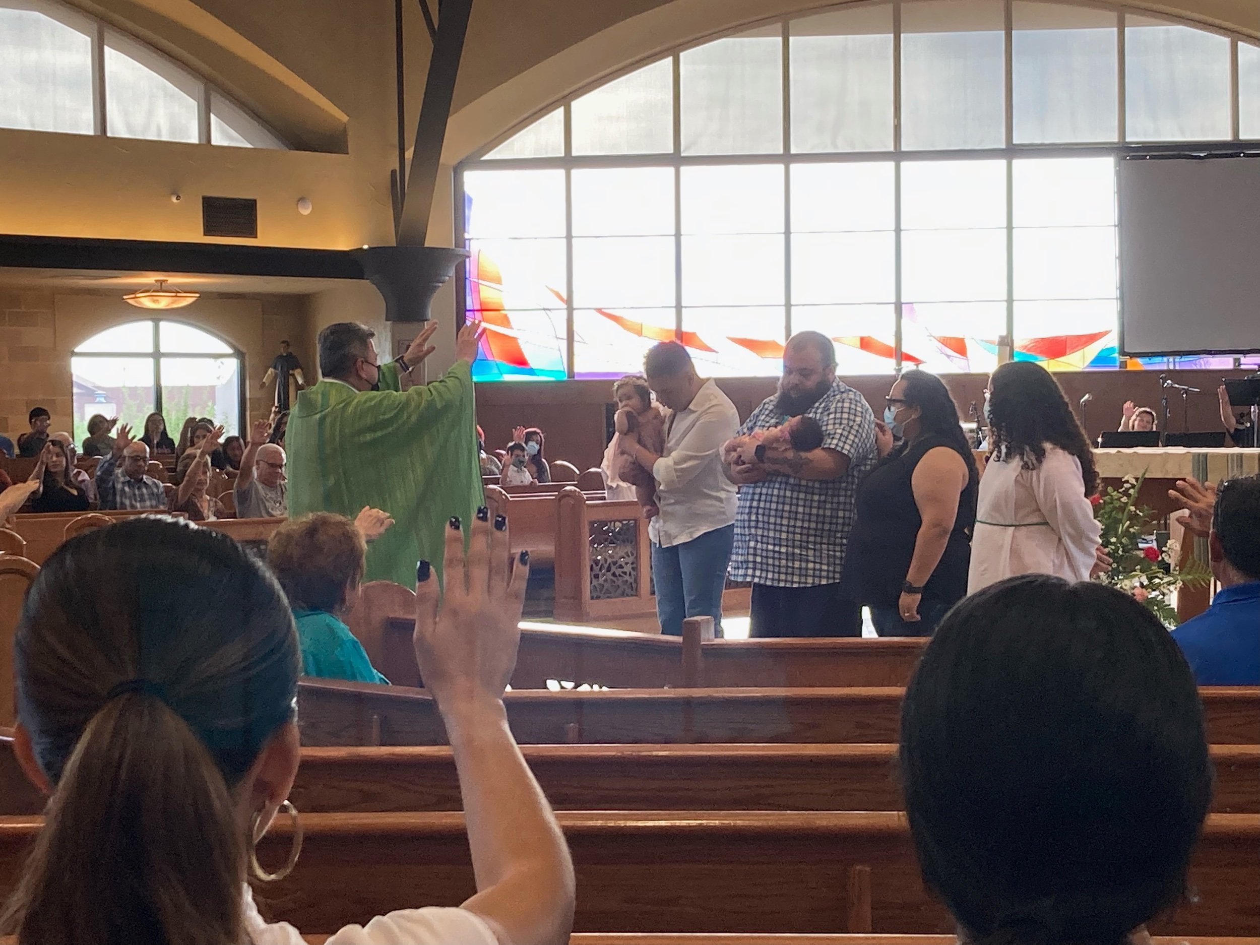 Fr. Ben welcoming 2 little ones to the Community and Blessed them.