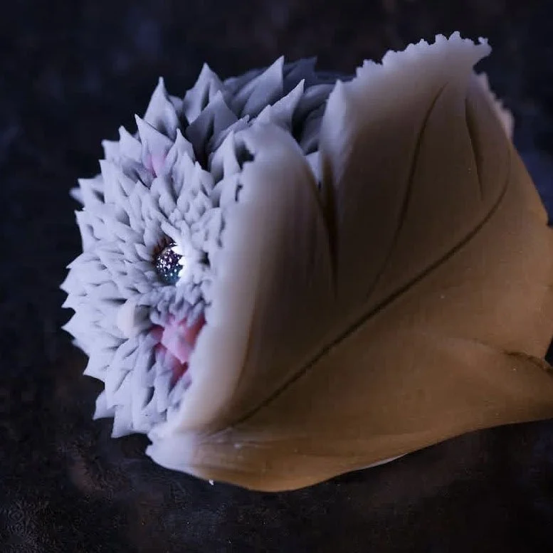 A rugged bloom peeks from beneath a sweeping boar-like fold, symbolizing Inosuke’s raw power and untamed spirit.