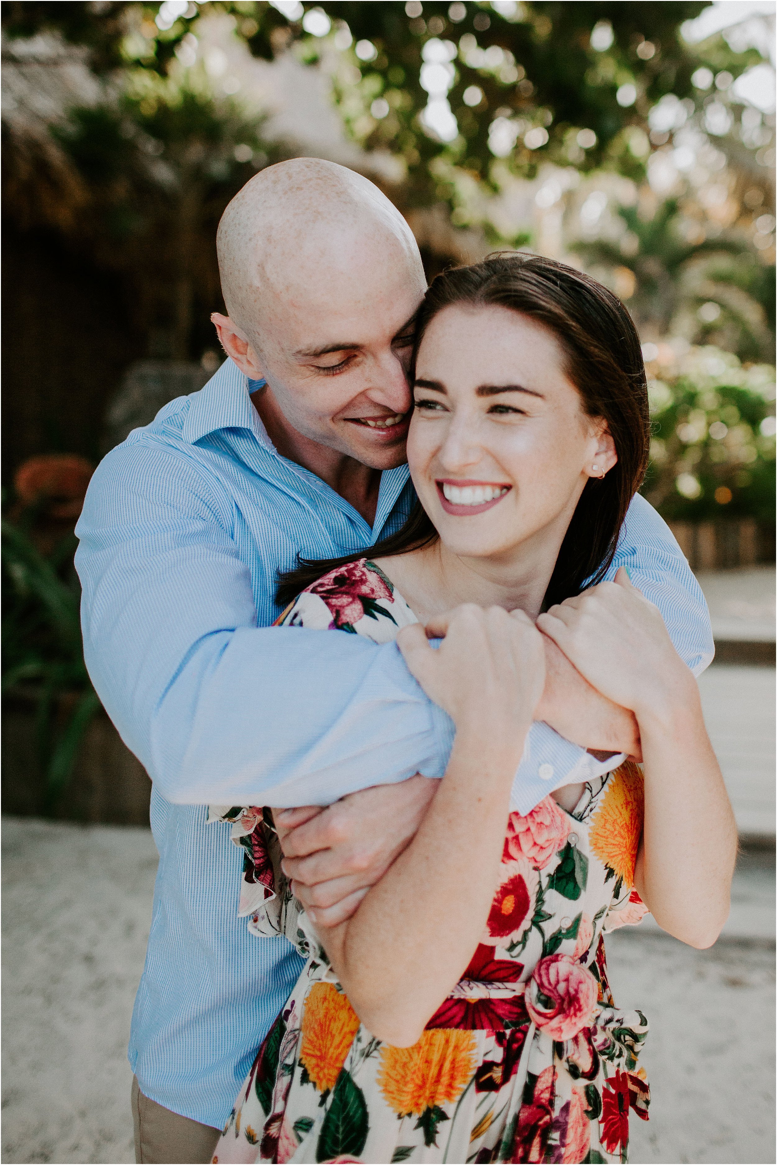  Couple portraits by large green palm leaves.  