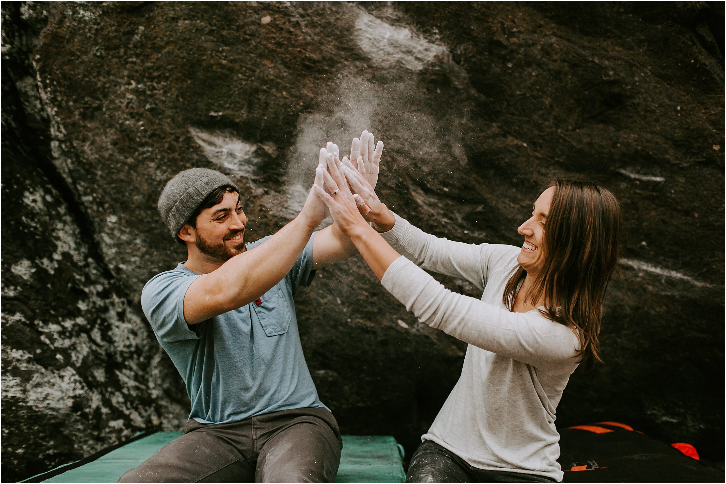  A couple high fiving with chalk on their hands. 