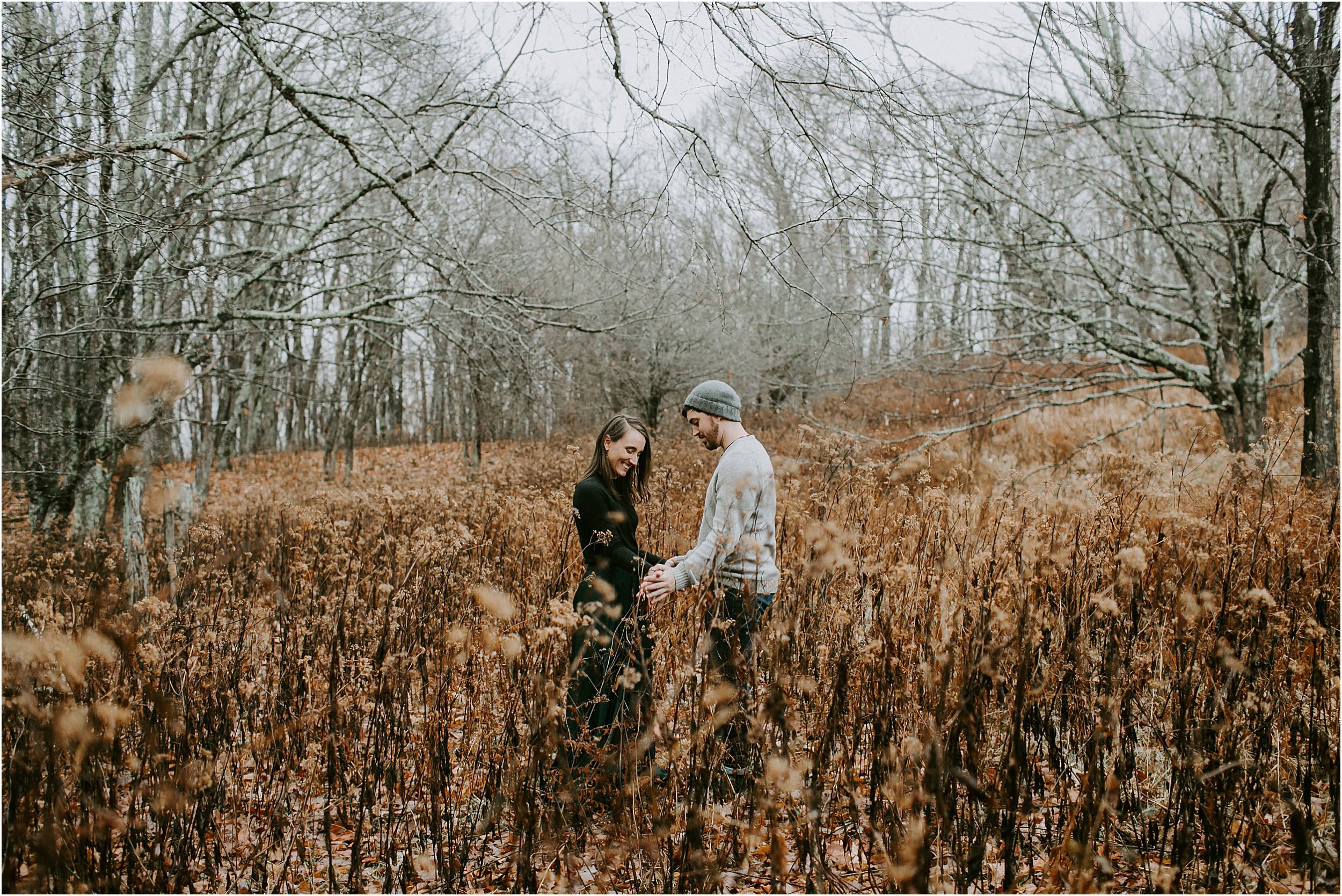  A couple explores the open field during their engagement session.  