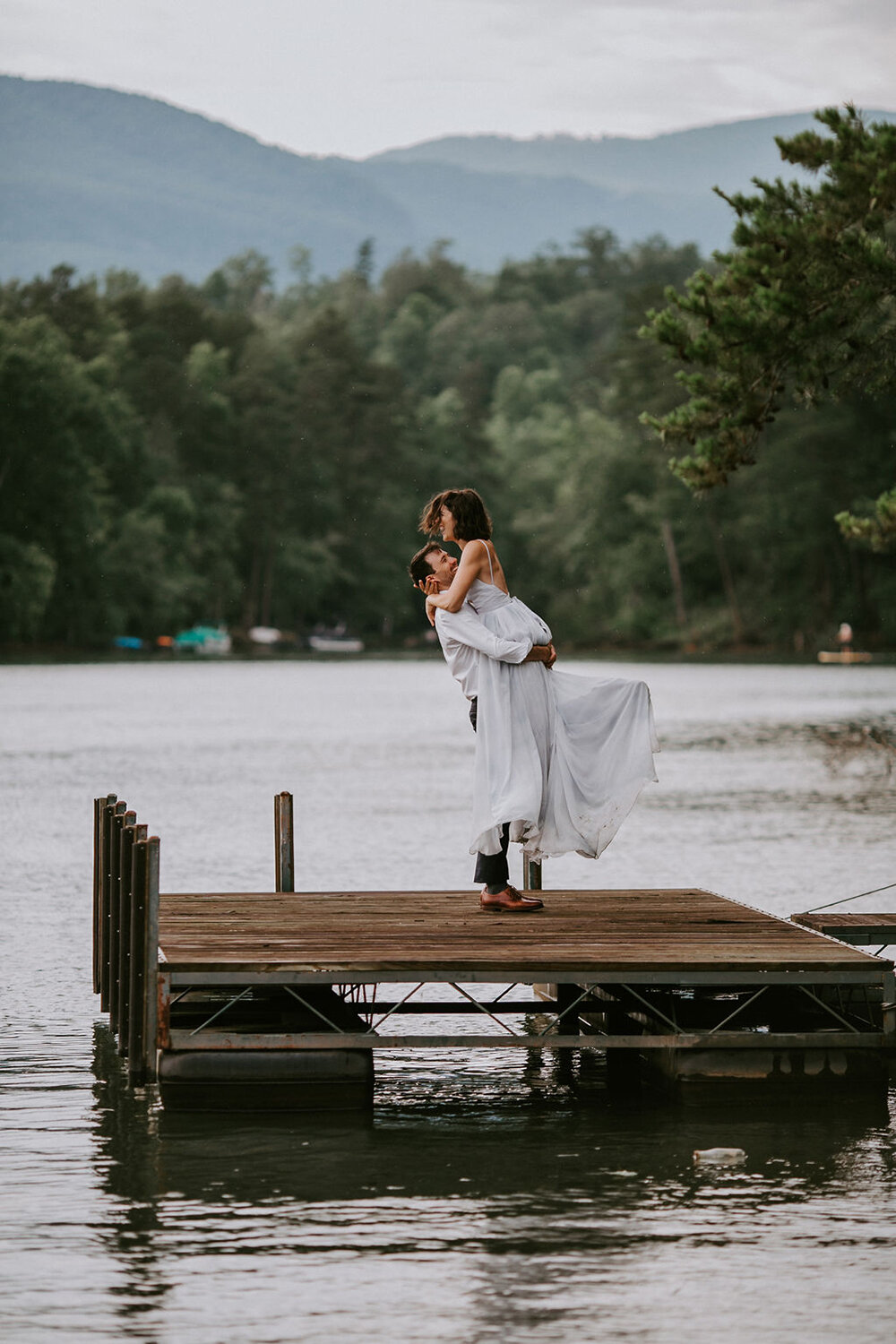 Bride and groom on a dock. 