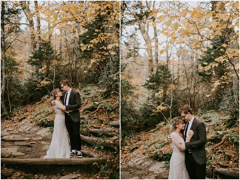 Bride and groom embracing each other in the woods.