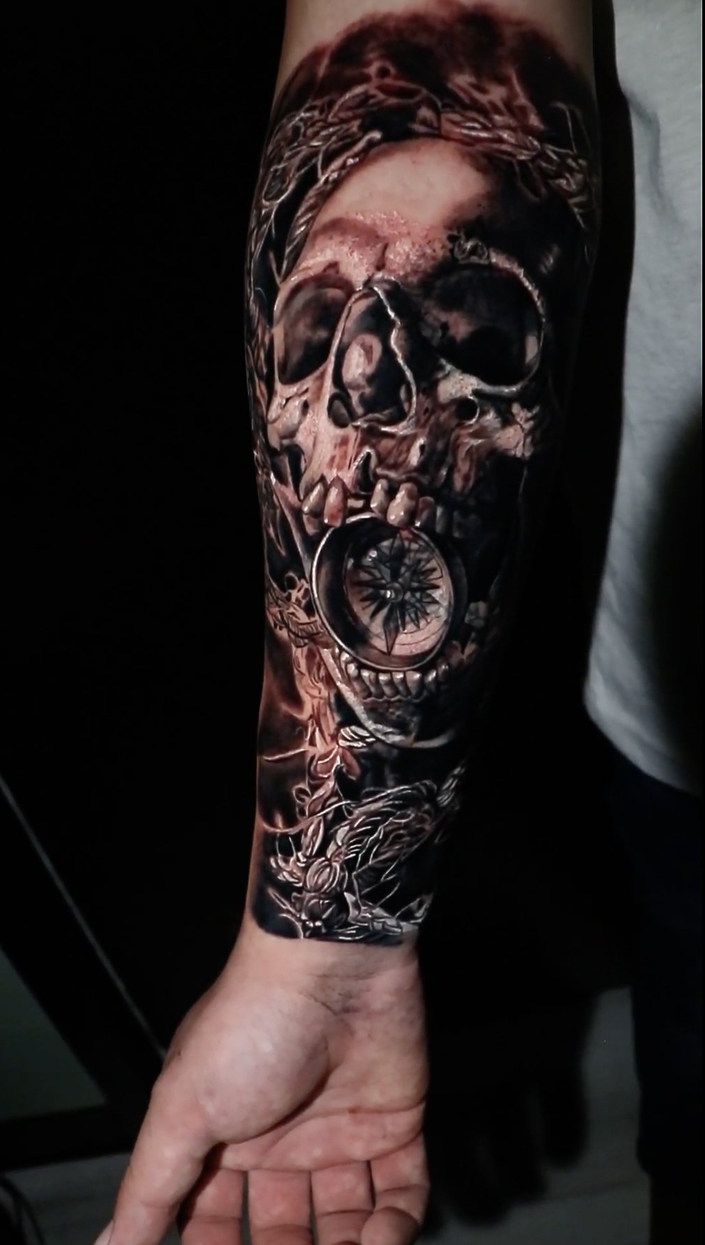 Realistic skull and compass tattoo on forearm by Chris Good at West Loop Tattoo Collective