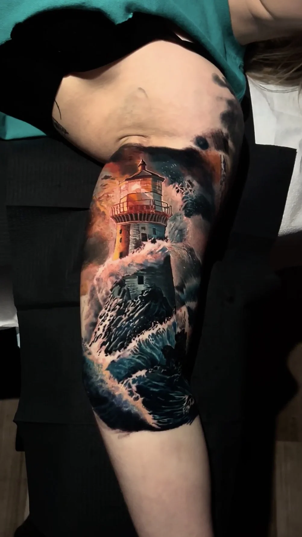 Illustrative Lighthouse in a storm tattoo by Chris Good at West Loop Tattoo Collective