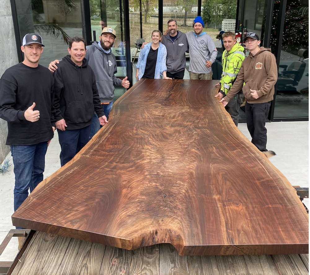 Happy clients and family with their new custom live edge walnut dining table delivered and installed by Kristopher Kirkpatrick in San Diego
