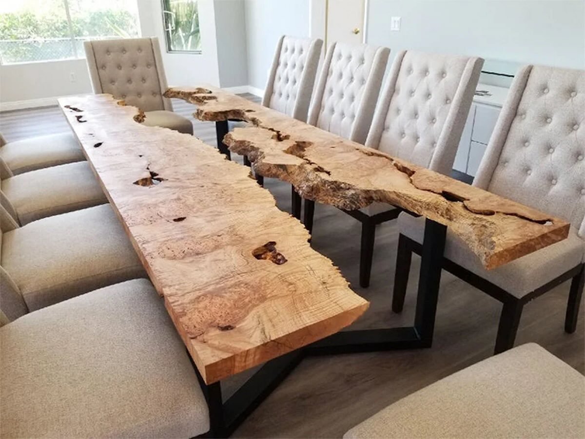 Extended live edge burled maple river table dining table with natural river gap and black steel base in a spacious dining area