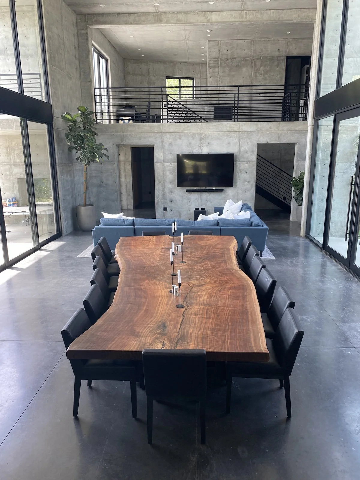 Large custom single-slab Claro walnut live edge dining table in a modern Los Angeles home