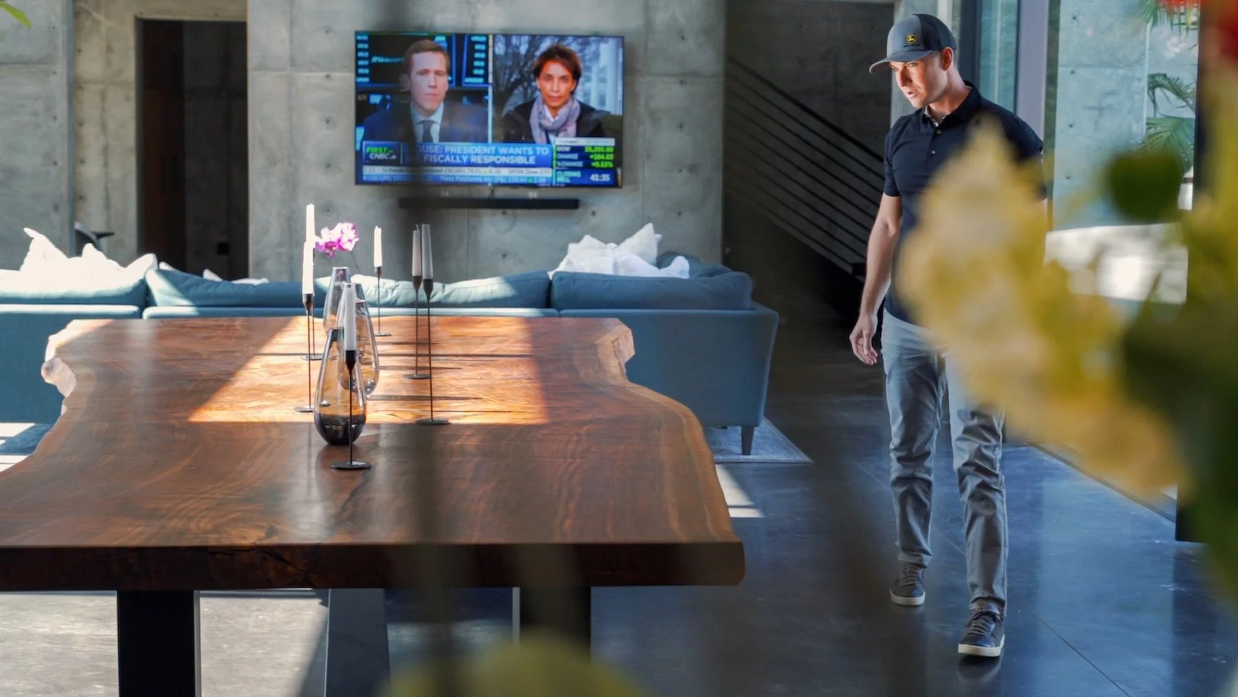 Kristopher Kirkpatrick standing beside his custom single-slab live edge claro walnut dining table made from a 150-year-old historic tree, handcrafted in San Diego.
