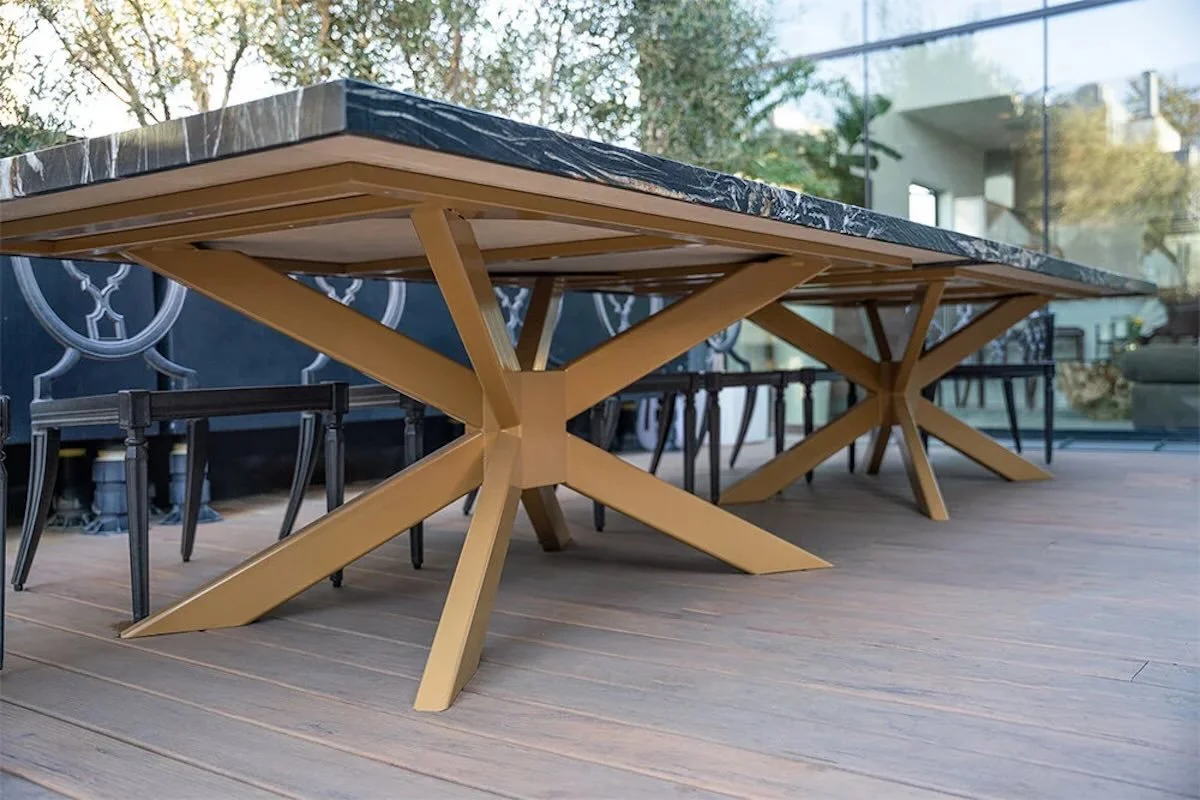 Close-up of custom steel starburst base on quartzite stone patio table showing construction details
