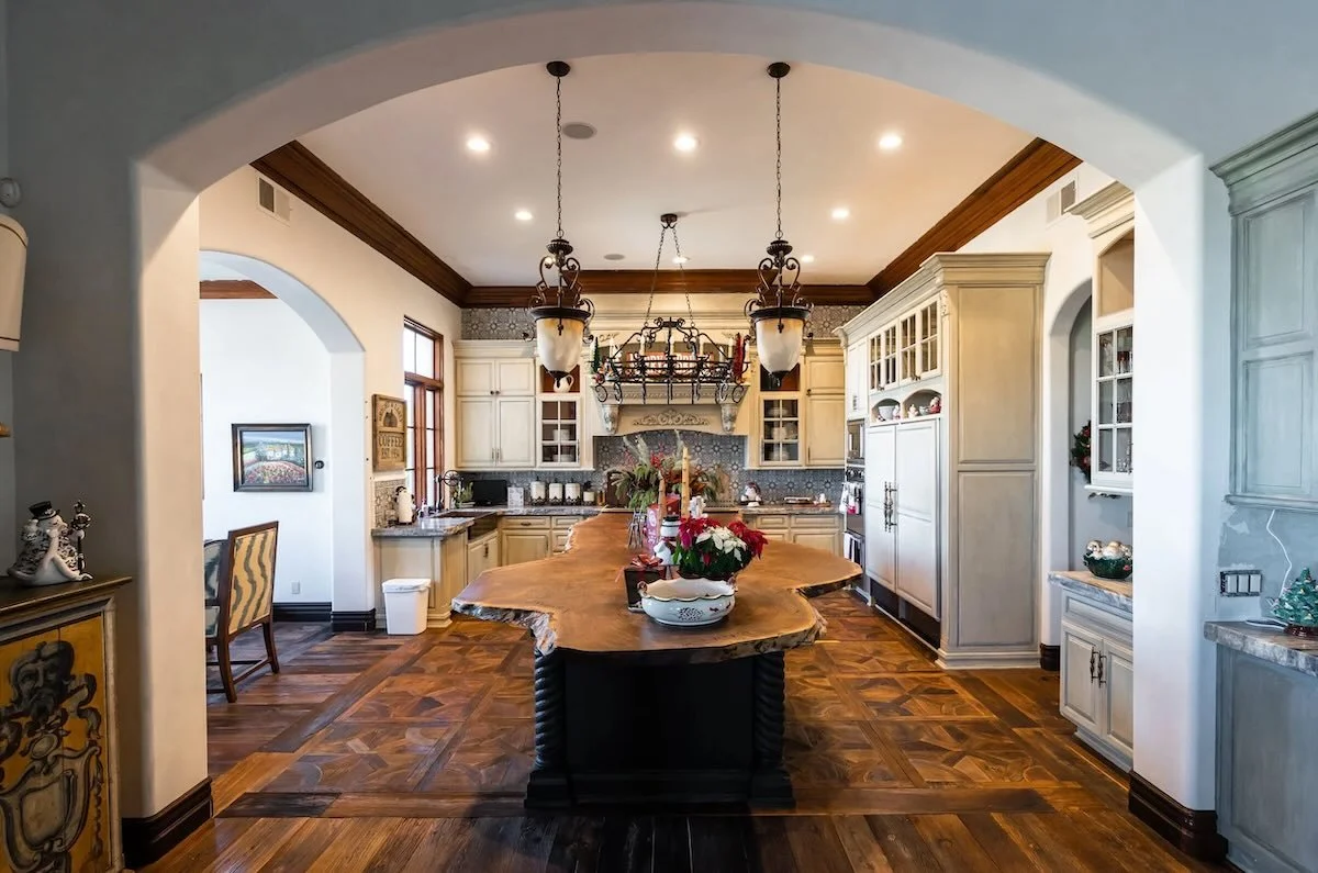 Live edge Claro walnut kitchen island featuring black twisted base and holiday decor in a warm kitchen setting