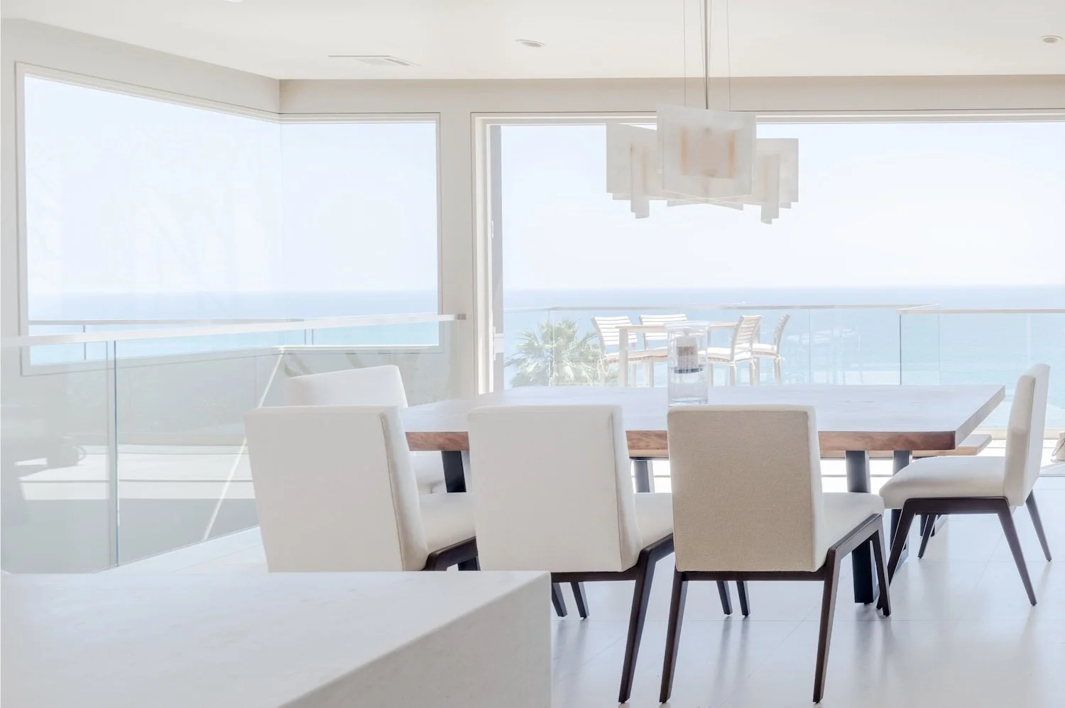 Custom handcrafted live edge walnut dining table by Kristopher Kirkpatrick in a luxury Laguna Beach oceanfront home with expansive Pacific Ocean views