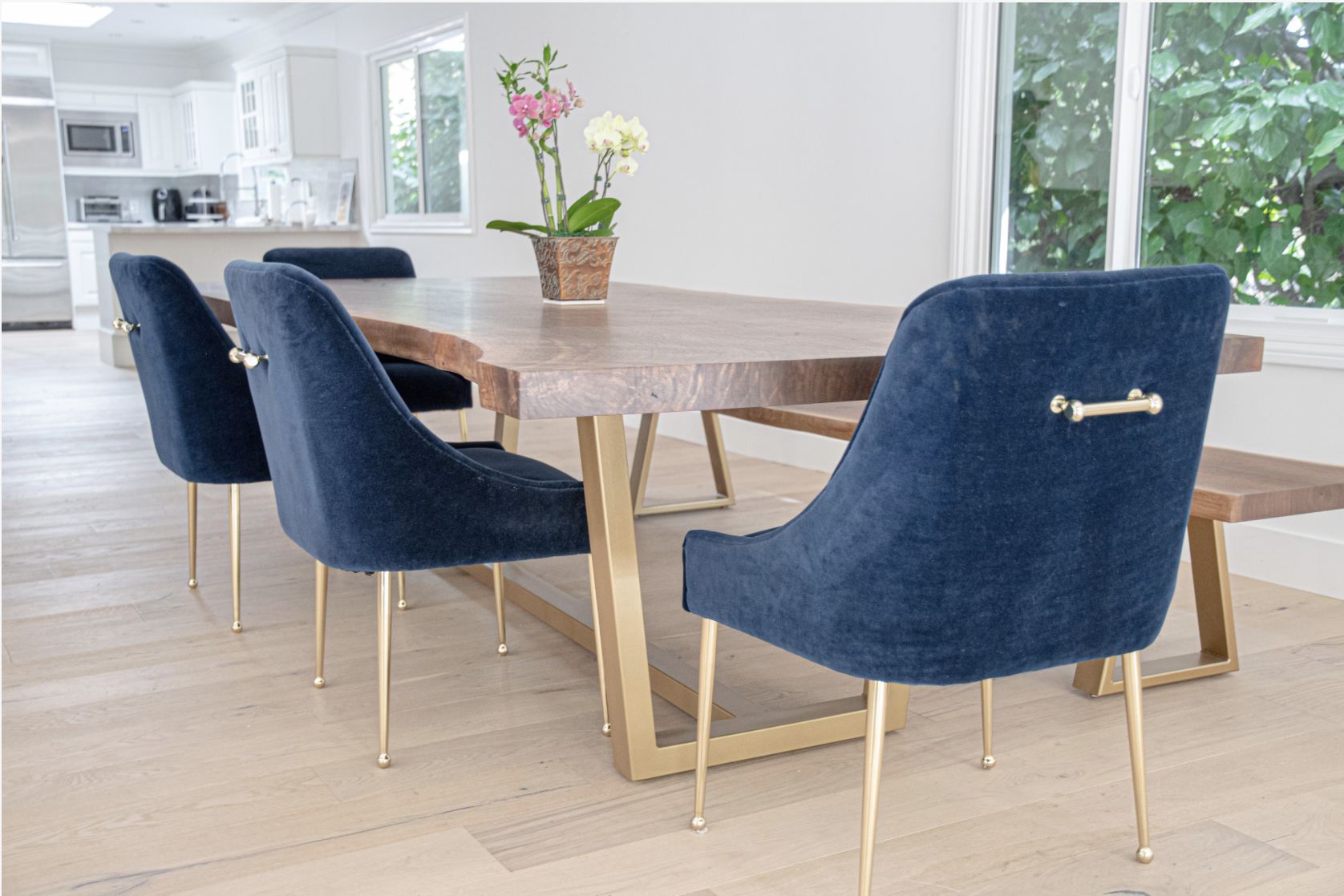 Custom 8-foot single slab Claro walnut live edge dining table with brushed gold steel base, handcrafted by Kristopher Kirkpatrick in San Diego, California.