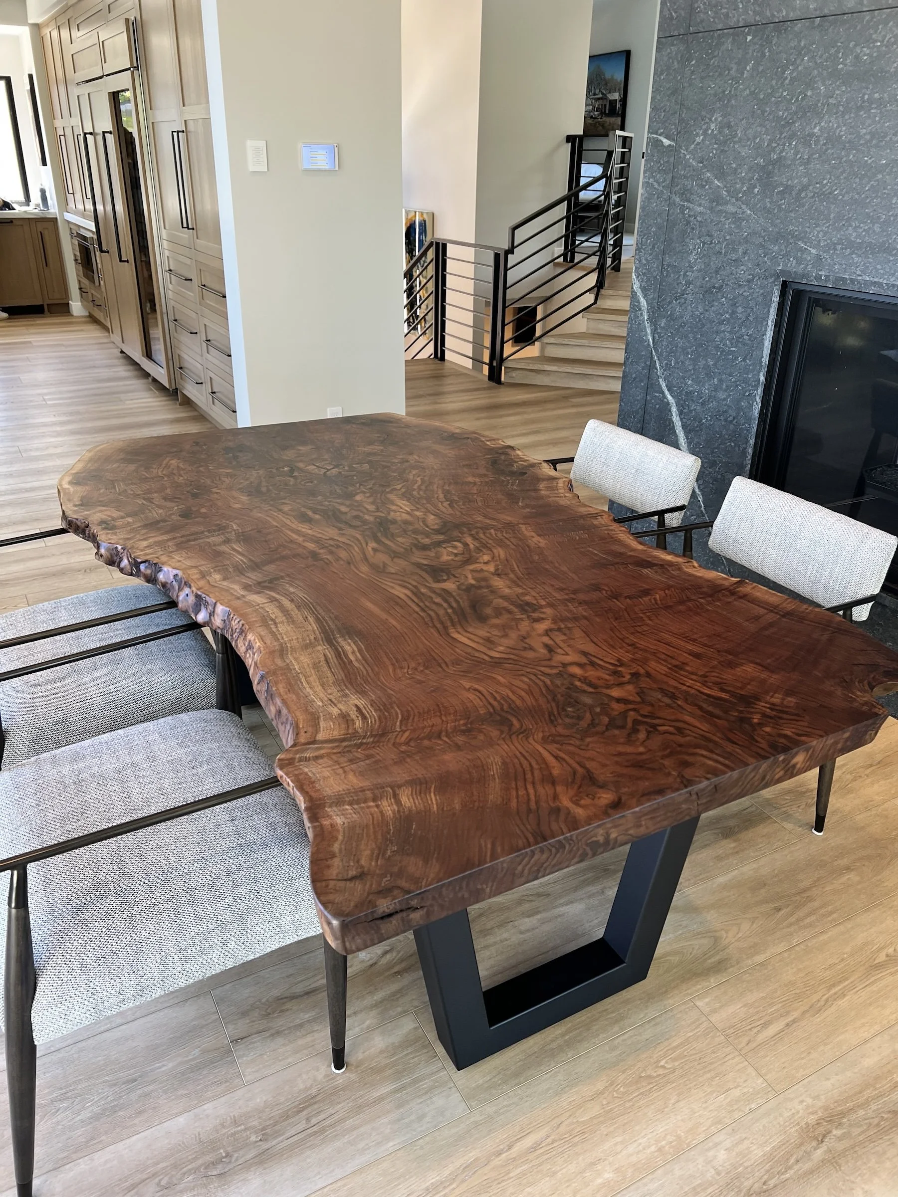 Custom Claro walnut live edge kitchen table with dramatic figured grain and black metal base