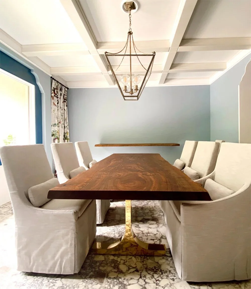 Handcrafted live edge Claro walnut dining table with brass wishbone legs, showcasing sculptural base design