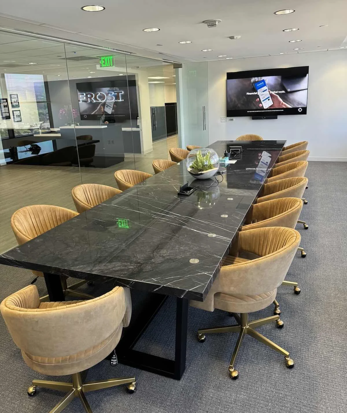 Premium quartzite conference table with dramatic veining and power grommets, shown in a high-end boardroom environment