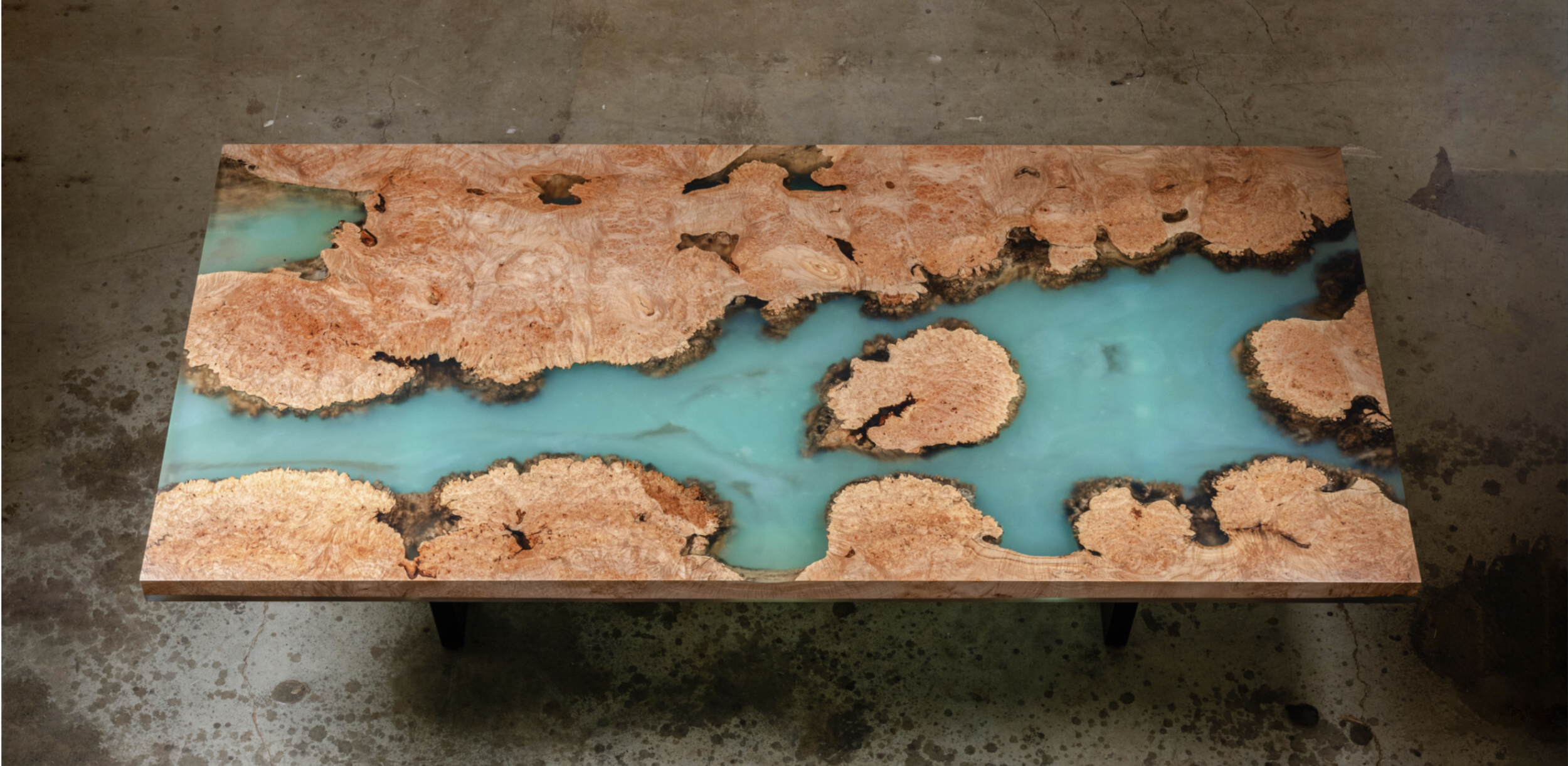 Custom epoxy resin river table featuring rich burled maple live edge and vibrant turquoise resin pour, handcrafted in San Diego