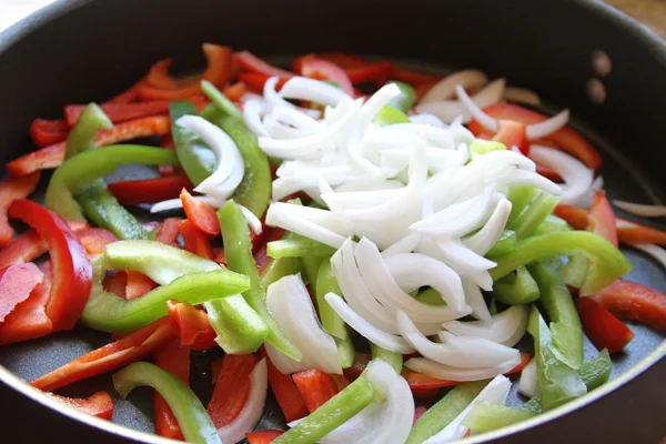 So first you need to saute your ingredients. I made 18 burritos in this tutorial so I used an entire white onion, and two large bell peppers. Which ever colors you like. I cooked everything with 1 1/2 tablespoons of olive oil and salt and pepper. Saute over medium heat for about 15 minutes. I prefer my peppers a little crunchy because remember you still have to microwave the burrito in the morning and that makes everything even more soft. In a separate pan you will need to make al your scrambled eggs. Figure 1 1/2 eggs per burrito.