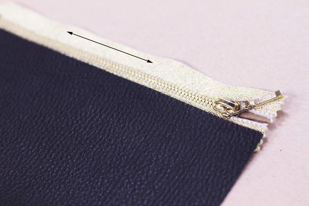 Now apply glue to the other side of the zipper and fold your leather so it sticks to the other side as shown below. Remember to apply glue to the entire length of the zipper.