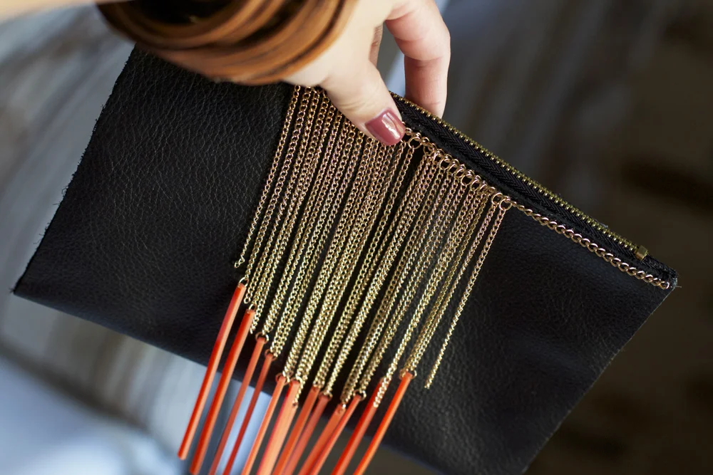 I made this one with a $5 fringe necklaces. I also attached this one with the Epoxy 6000. It's very secure on the clutch.