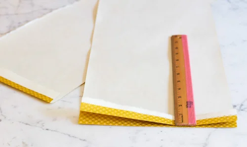 Take each half and start fanning the paper back and forth. Each fold should be 1" wide.