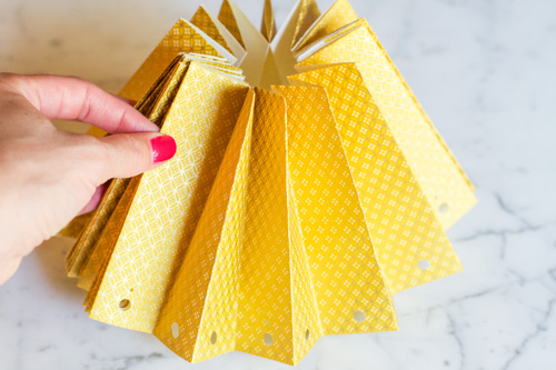 Now push your rosette towards the middle so all the pieces lift up. You are going to put a dab of glue on the center pieces.