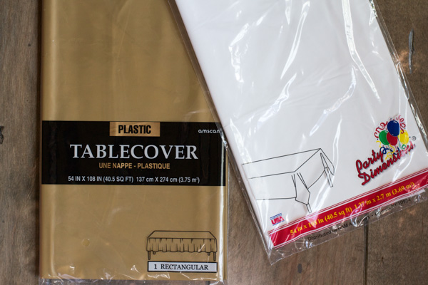 Alright, let's get started. For the fringe we used these super cheap classic plastic table covers. These are $1 each and you get 12 fringe tassels out of each table cover.