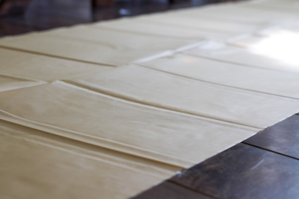 Completely unfold your plastic table cover until it's only folded in half ONE time. It should be folded horizontally once.