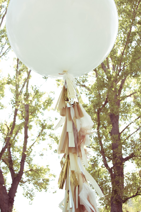 Now this is where you get creative. We added feathers to our balloons. You could easily add colorful ribbon as well. It just makes the balloon even more special.