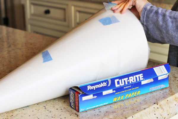 Now wrap your cone with wax paper. This is going to come out of the piñata when we are done.