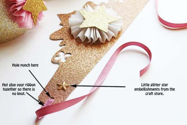 The final step is to hole punch the ends of your crown and string your ribbon through. Make sure not to put your hole punches to close to the ends. Hot glue your ribbon together instead of tying a knot. This makes it more secure and it looks better.