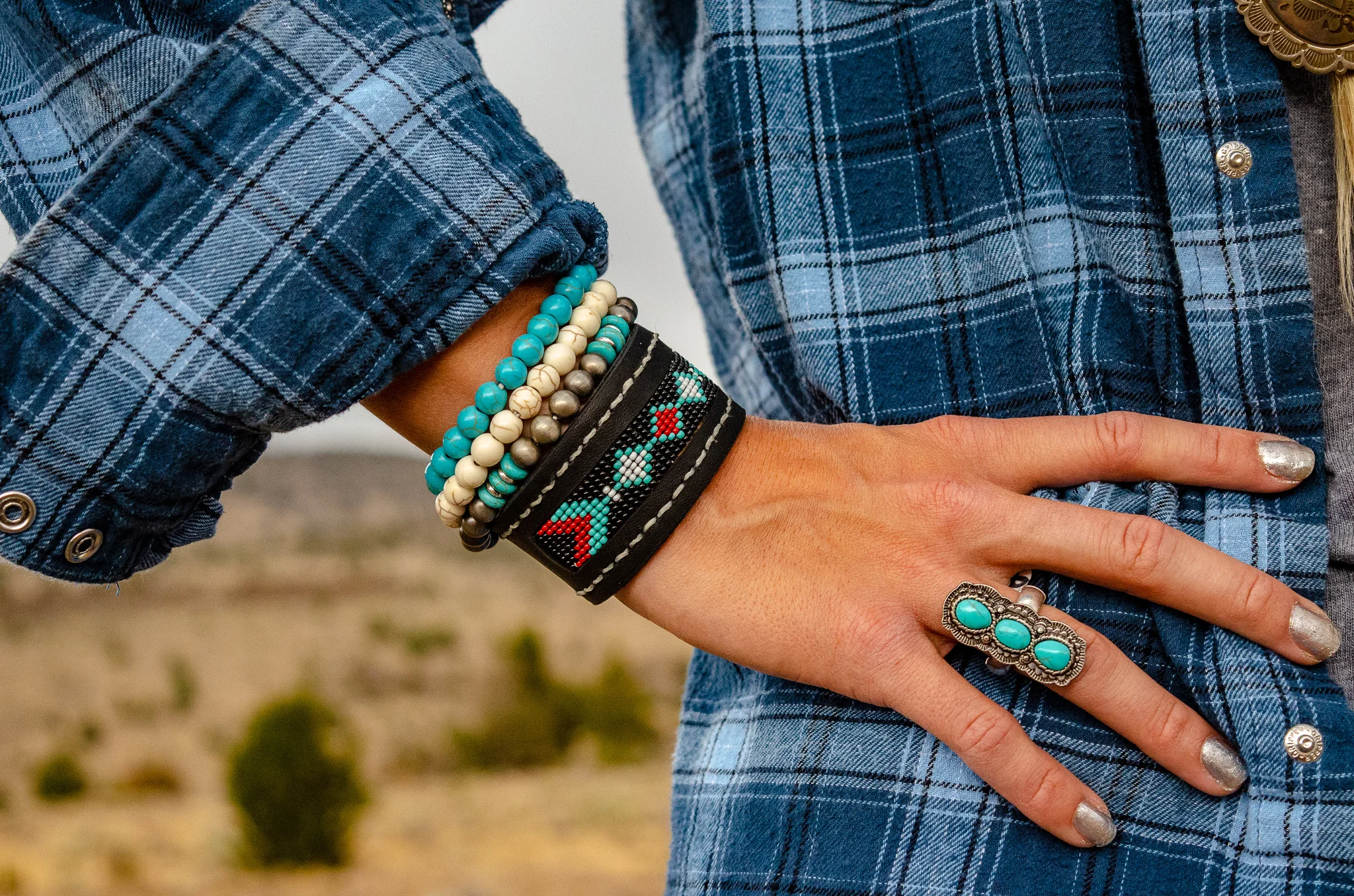 Beautifully beaded cuff by Flyin’ A Custom Leather and Beading. Other bracelets & ring by The Rustic Ranch. Vintage Wrangler by The Desert Wind Boutique.