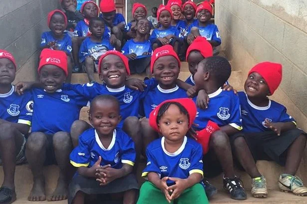 Youngsters in Malawi wearing Everton shirts shipped over last year.