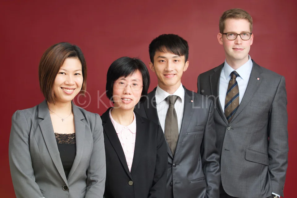 Group corporate headshots Hong Kong Central in front of red wall