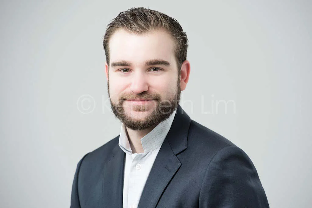 corporate headshot hong kong executive light background male smiling friendly