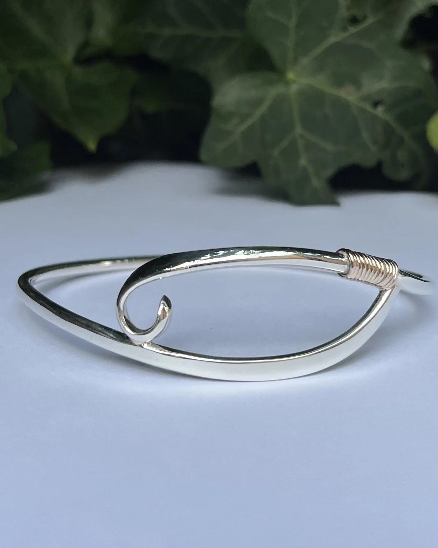 Silver bangle with gold wire.