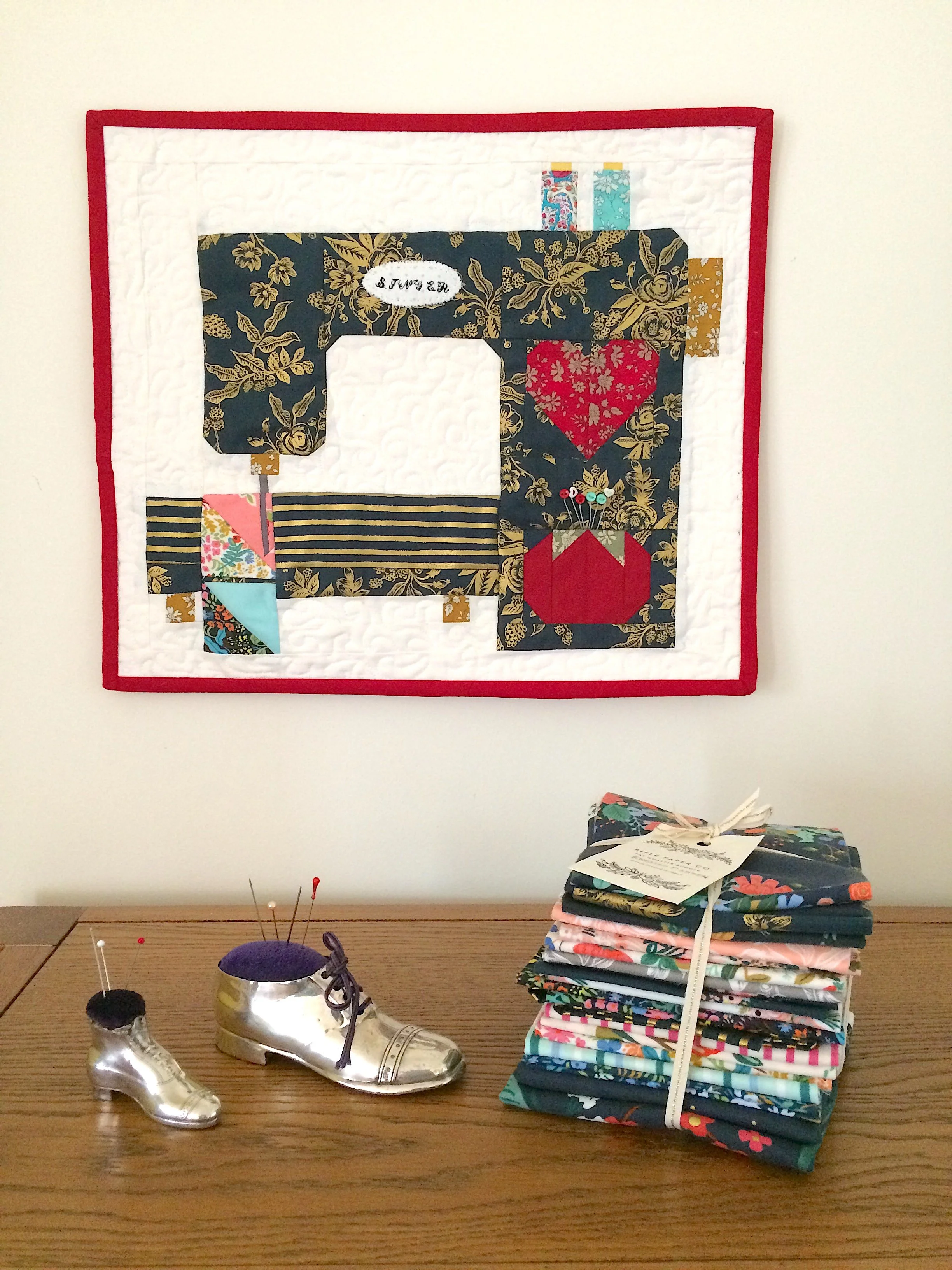 Stitched with love finished mini quilt.JPG