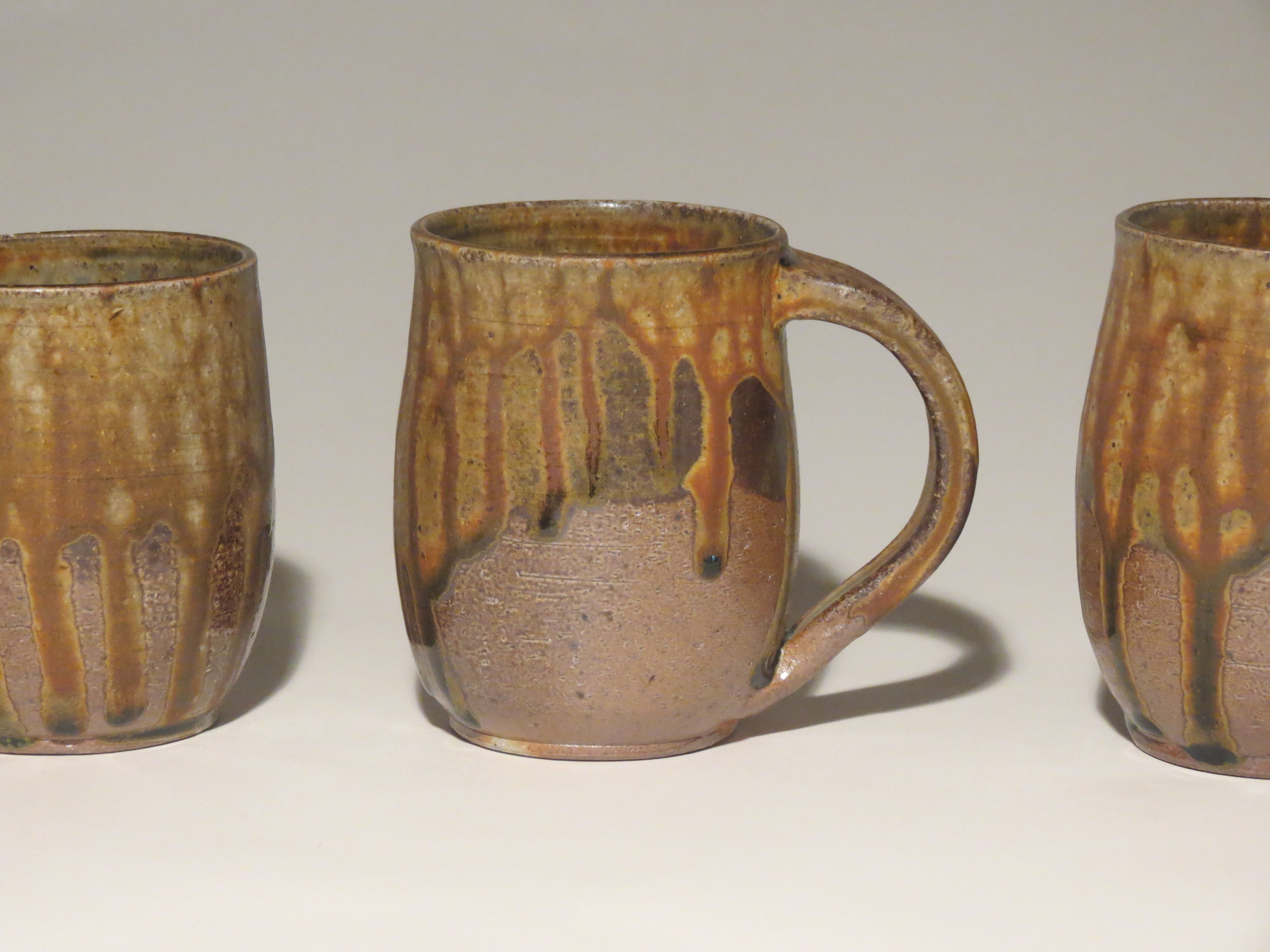  wood-fired mugs with ash and tenmoku glaze. 