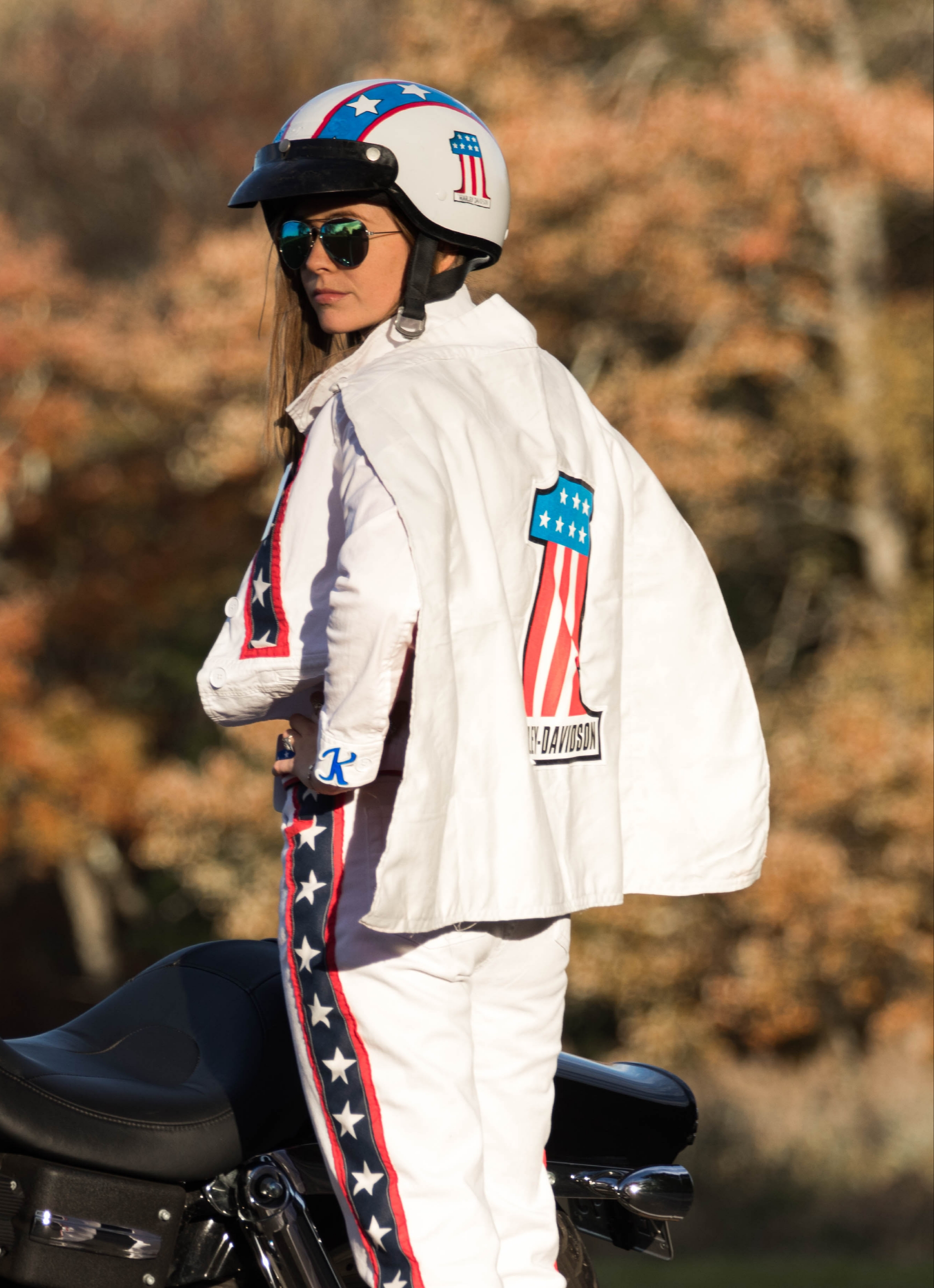 2018 Created Evel Kinevel costume. Printed #1 logo, Machine and hand stitched stars and red stripes onto white apparel, hand painted helmet, designed and sowed cape together